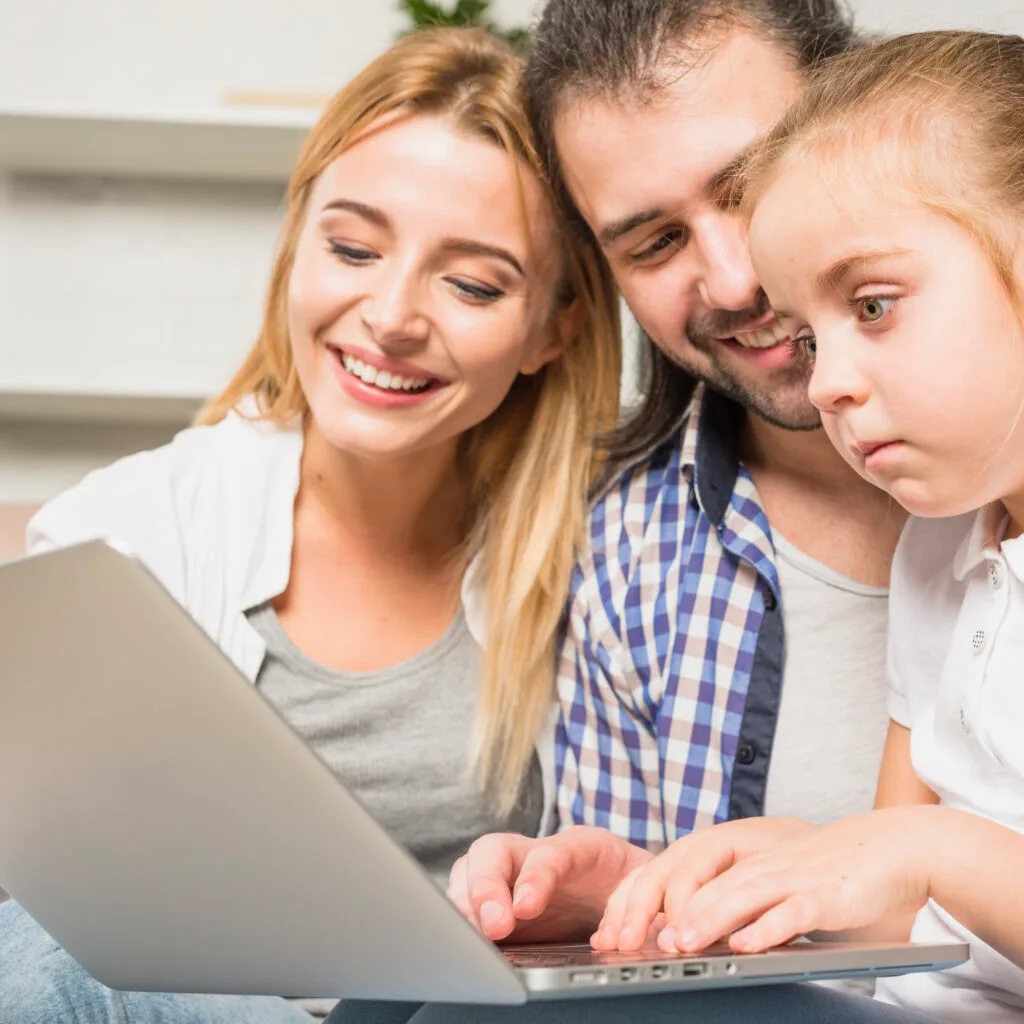 family-using-laptop-sofa
